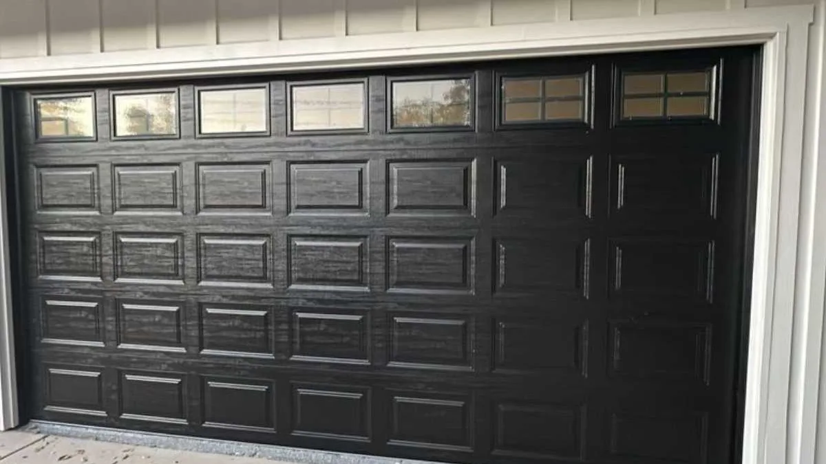 Black aluminium full-view garage door with a grid of glass panels