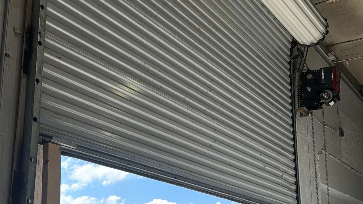 Garage door opener rail and track mounted to a finished wood ceiling